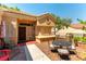 Charming outdoor patio area with a grill, dining set, and comfortable seating at 8516 Millsboro Dr, Las Vegas, NV 89134