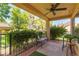 Relaxing covered patio with ceiling fan, seating and view of well-manicured yard at 8516 Millsboro Dr, Las Vegas, NV 89134