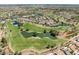 Golf course, lakes and greens, and residential homes nestled in the scenic community at 8629 Prairie Hill Dr, Las Vegas, NV 89134