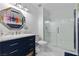 Well-lit bathroom features navy vanity, modern mirror, and glass-enclosed shower with white subway tile at 8629 Prairie Hill Dr, Las Vegas, NV 89134
