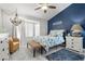 Charming bedroom featuring decorative blue accent wall, detailed chandelier, and beach decor at 8629 Prairie Hill Dr, Las Vegas, NV 89134
