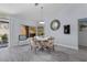 Cozy dining area with outdoor view, modern mirror, and stylish cowhide chairs at 8629 Prairie Hill Dr, Las Vegas, NV 89134