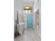 Bright foyer featuring wood-look floors, transom window, and painted door adding character and charm to the home at 8629 Prairie Hill Dr, Las Vegas, NV 89134