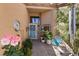 Inviting front entryway featuring stone pathway, potted plants, a charming chair, and stylish decor, creating a welcoming ambiance at 8629 Prairie Hill Dr, Las Vegas, NV 89134