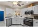 A well-lit modern kitchen with stainless steel appliances and white cabinets at 8629 Prairie Hill Dr, Las Vegas, NV 89134