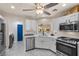 Modern kitchen with stainless steel appliances, white cabinets, and an adjacent laundry area at 8629 Prairie Hill Dr, Las Vegas, NV 89134