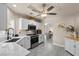 Open-concept kitchen with white cabinets, stainless steel appliances, and views into the dining area at 8629 Prairie Hill Dr, Las Vegas, NV 89134