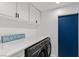 Organized laundry room with front load washer/dryer and beach house decor at 8629 Prairie Hill Dr, Las Vegas, NV 89134