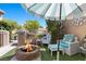 Inviting outdoor living space features a cozy fire pit, comfortable seating, and a stylish umbrella for shade at 8629 Prairie Hill Dr, Las Vegas, NV 89134