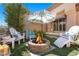 Cozy backyard features a charming fire pit area with comfortable seating and shade perfect for outdoor gatherings at 8629 Prairie Hill Dr, Las Vegas, NV 89134