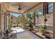 Covered patio with barbecue grill, seating area, and garden views at 8629 Prairie Hill Dr, Las Vegas, NV 89134