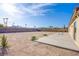 Expansive backyard with a concrete patio perfect for outdoor seating and desert landscaping at 8665 Jerlyn St, Las Vegas, NV 89113