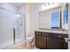 Bathroom features a glass-enclosed shower, modern vanity, and granite countertop at 8665 Jerlyn St, Las Vegas, NV 89113