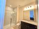 This bathroom features a marble shower, toilet, mirror, and granite countertop sink at 8665 Jerlyn St, Las Vegas, NV 89113