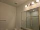 Bathroom featuring a framed glass shower enclosure, mirror, vanity, and lighting at 8665 Jerlyn St, Las Vegas, NV 89113