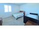 Bright bedroom features neutral carpeting, two beds, and natural light from the window at 8665 Jerlyn St, Las Vegas, NV 89113