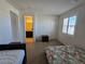 Open bedroom with ensuite bath, neutral walls, carpeting, and a sun-filled window at 8665 Jerlyn St, Las Vegas, NV 89113