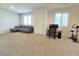 Large bonus room with neutral carpeting, a sectional sofa, and dedicated office space at 8665 Jerlyn St, Las Vegas, NV 89113