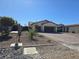 Landscaped front yard featuring desert landscaping and a private driveway at 8665 Jerlyn St, Las Vegas, NV 89113