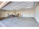 Spacious two-car garage with ample storage and workspace, featuring a concrete floor at 8665 Jerlyn St, Las Vegas, NV 89113