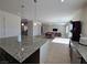 Open-concept kitchen with granite countertops that flows into a spacious living area at 8665 Jerlyn St, Las Vegas, NV 89113