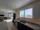 Modern kitchen with sleek granite countertops, dark cabinets, and stainless steel appliances at 8665 Jerlyn St, Las Vegas, NV 89113