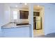 Stylish kitchenette featuring a breakfast bar with granite counters and dark cabinetry at 8665 Jerlyn St, Las Vegas, NV 89113
