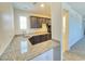 Open kitchenette design with granite countertops, dark cabinetry, and stainless steel sink at 8665 Jerlyn St, Las Vegas, NV 89113