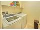Bright laundry room with a washer and dryer, and storage shelving above at 8665 Jerlyn St, Las Vegas, NV 89113