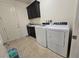 Functional laundry room with a sink, cabinet, and modern washer and dryer at 8665 Jerlyn St, Las Vegas, NV 89113