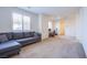 Comfortable living room with a plush gray sectional sofa and large windows providing ample natural light at 8665 Jerlyn St, Las Vegas, NV 89113
