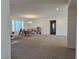 Open-concept living area with neutral carpet and ample natural light, perfect for versatile use at 8665 Jerlyn St, Las Vegas, NV 89113