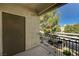 Balcony view with black metal railing overlooking trees and parking area at 9050 W Warm Springs Rd # 2051, Las Vegas, NV 89148