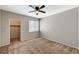 Neutral-toned bedroom features a ceiling fan, window with blinds, and closet with ample storage space at 9050 W Warm Springs Rd # 2051, Las Vegas, NV 89148