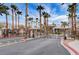 Gated entrance to the community with mature palm trees lining the street at 9050 W Warm Springs Rd # 2051, Las Vegas, NV 89148