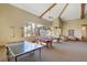 Spacious game room featuring ping pong and pool tables, natural light, and comfortable seating area at 9050 W Warm Springs Rd # 2051, Las Vegas, NV 89148