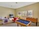 Well-lit game room equipped with a foosball table, air hockey, TV, and comfortable seating at 9050 W Warm Springs Rd # 2051, Las Vegas, NV 89148