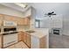 A functional kitchen area with gas range stove and view to the living area at 9050 W Warm Springs Rd # 2051, Las Vegas, NV 89148