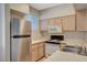 A well-lit kitchen featuring stainless steel refrigerator and ample counter space at 9050 W Warm Springs Rd # 2051, Las Vegas, NV 89148