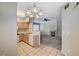A cozy kitchen with wood cabinets and tile flooring leading to a living area with a fireplace at 9050 W Warm Springs Rd # 2051, Las Vegas, NV 89148
