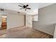Open living area with a balcony, ceiling fan, and an adjacent kitchen space at 9050 W Warm Springs Rd # 2051, Las Vegas, NV 89148