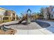 Community playground with slide and play structure near townhouse residences on a sunny day at 9050 W Warm Springs Rd # 2051, Las Vegas, NV 89148