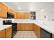 Functional kitchen with wooden cabinets, modern appliances, and tile backsplash, perfect for cooking and dining at 913 Duckhorn Ct # 204, Las Vegas, NV 89144