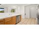 Bright open-concept kitchen with stainless steel dishwasher and wood cabinets at 913 Duckhorn Ct # 204, Las Vegas, NV 89144