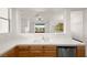 Bright open-concept kitchen with stainless steel dishwasher and wood cabinets at 913 Duckhorn Ct # 204, Las Vegas, NV 89144