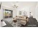 Bright living room featuring a neutral color palette, ceiling fan, and sliding glass doors leading to a balcony at 913 Duckhorn Ct # 204, Las Vegas, NV 89144