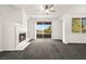 Spacious living room with fireplace and sliding door access to the outdoor balcony at 913 Duckhorn Ct # 204, Las Vegas, NV 89144