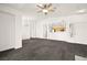 Open living room with view of the kitchen and carpeted floor at 913 Duckhorn Ct # 204, Las Vegas, NV 89144