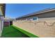 Backyard with artificial turf, block wall, and string lights at 924 Allister Fields Ln, Las Vegas, NV 89138