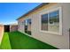 Well-maintained backyard features artificial grass and sliding glass door at 924 Allister Fields Ln, Las Vegas, NV 89138
